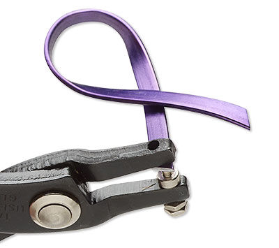 Hole punching one end of the metal purple ribbon 